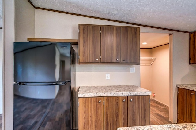 2832 Two Mile Rd, Winchester, KY 40391 - kitchen with freestanding refrigerator, wood finished floors, light countertops, a textured ceiling, and ornamental molding