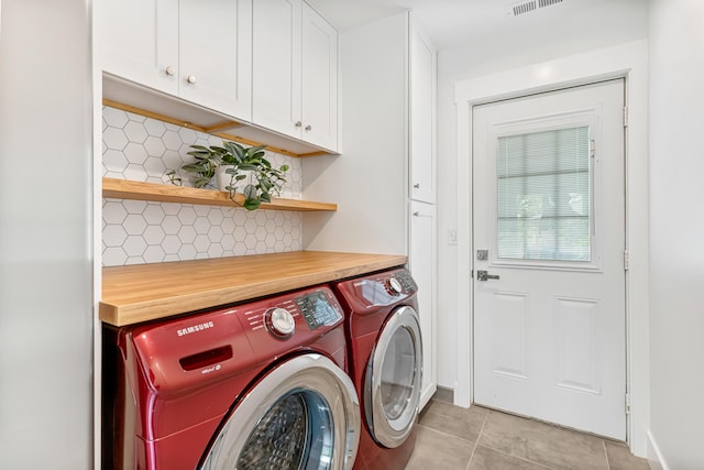 1251 Wilmore Rd, Nicholasville, KY 40356 - laundry area featuring washer and clothes dryer, cabinet space, and light tile patterned floors