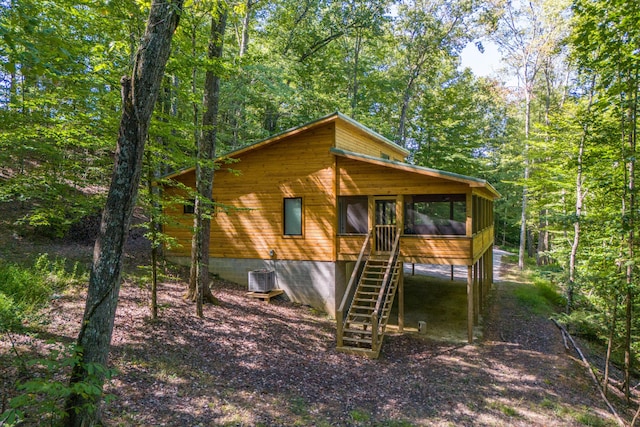 3786 Shoemaker Rdg, Beattyville, KY 41311 - view of front of home featuring a sunroom, stairway, and central AC unit
