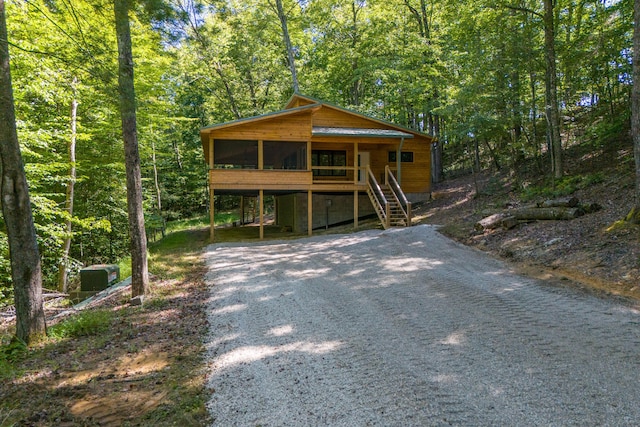 3786 Shoemaker Rdg, Beattyville, KY 41311 - view of front of home featuring a sunroom, driveway, and a view of trees