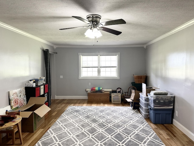 498 Winding Blade Rd, East Bernstadt, KY 40729 - misc room featuring wood finished floors, a textured ceiling, a ceiling fan, ornamental molding, and baseboards