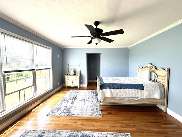 498 Winding Blade Rd, East Bernstadt, KY 40729 - bedroom featuring crown molding, wood finished floors, baseboards, and ceiling fan