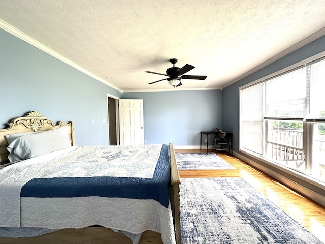 498 Winding Blade Rd, East Bernstadt, KY 40729 - bedroom with ornamental molding, wood finished floors, ceiling fan, baseboards, and a textured ceiling