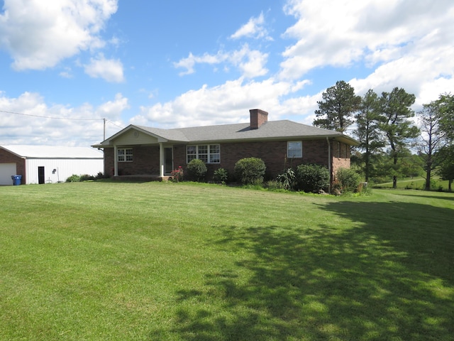 498 Winding Blade Rd, East Bernstadt, KY 40729 - ranch-style home featuring a front yard, a chimney, brick siding, and a garage