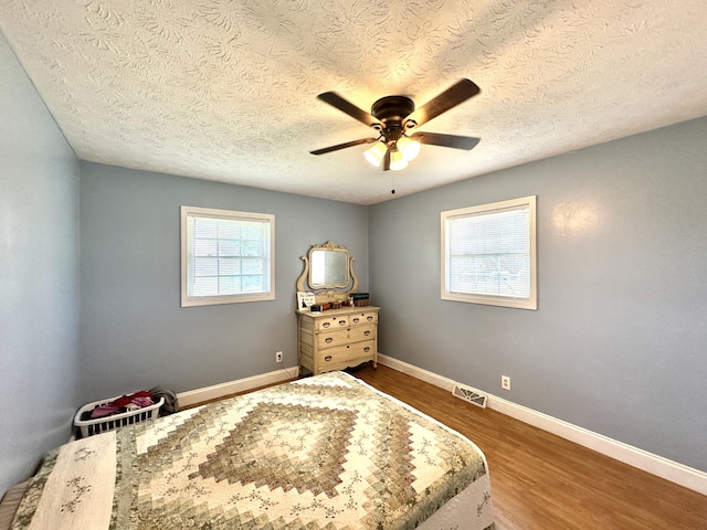 498 Winding Blade Rd, East Bernstadt, KY 40729 - bedroom with dark wood-type flooring, a textured ceiling, baseboards, and ceiling fan