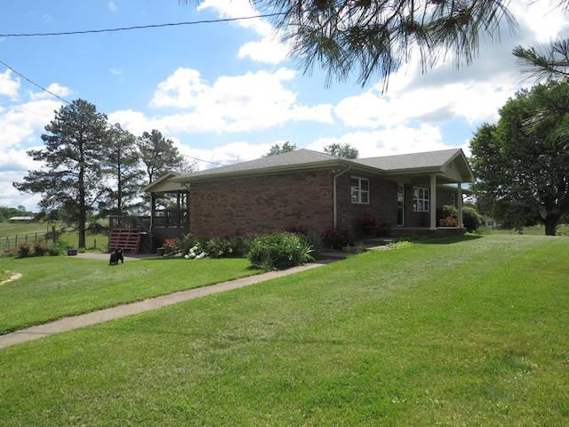 498 Winding Blade Rd, East Bernstadt, KY 40729 - view of side of property with brick siding, a lawn, and a wooden deck