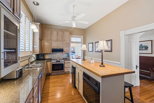 1483 Cypress St, Paris, KY 40361 - kitchen featuring appliances with stainless steel finishes, a sink, exhaust hood, a kitchen bar, and butcher block countertops