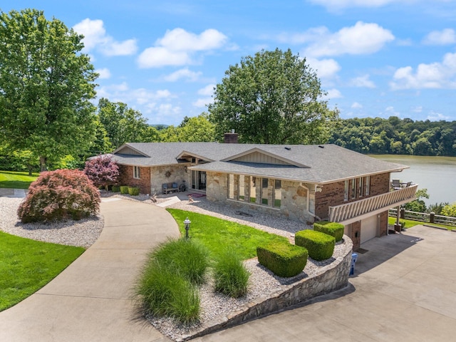 275 Lakeview Dr, Somerset, KY 42503 - view of front of home featuring stone siding, driveway, a garage, a water view, and a chimney