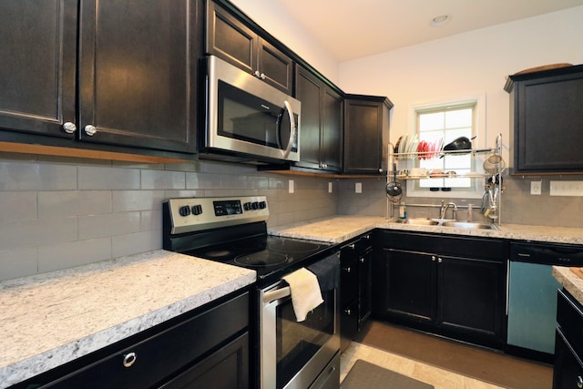 2592 Mable Ln, Lexington, KY 40511 - kitchen featuring stainless steel appliances, a sink, backsplash, and light countertops