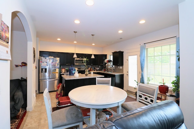 2592 Mable Ln, Lexington, KY 40511 - kitchen with appliances with stainless steel finishes, a center island, dark cabinetry, recessed lighting, and pendant lighting