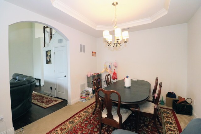 2592 Mable Ln, Lexington, KY 40511 - dining area featuring arched walkways, a chandelier, a raised ceiling, carpet, and crown molding