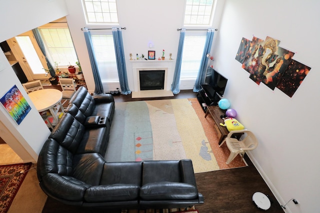 2592 Mable Ln, Lexington, KY 40511 - living area with a fireplace with raised hearth, a towering ceiling, and plenty of natural light
