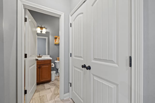 929 Lauderdale Dr, Lexington, KY 40515 - half bathroom featuring toilet, marble look tile flooring, vanity, and baseboards