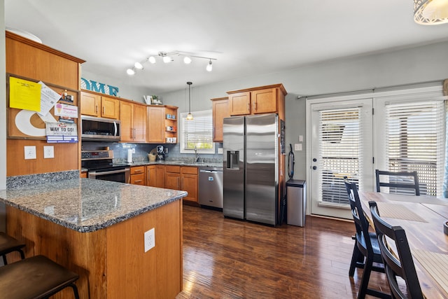 929 Lauderdale Dr, Lexington, KY 40515 - kitchen featuring appliances with stainless steel finishes, open shelves, a sink, brown cabinets, and a peninsula