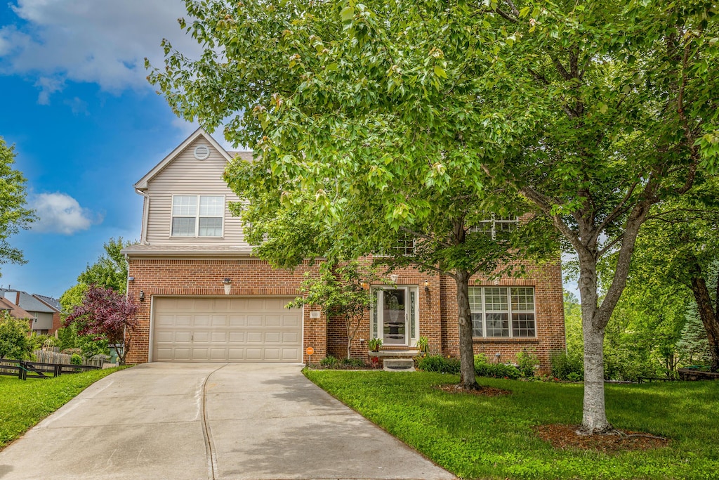 4201 Mattea Ct, Lexington, KY 40514 - obstructed view of property featuring brick siding, a front lawn, driveway, and an attached garage