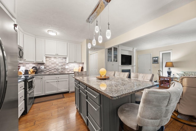 42-1 Woodson Bend Resort, Bronston, KY 42518 - kitchen with open floor plan, stainless steel appliances, a kitchen breakfast bar, white cabinetry, and a sink
