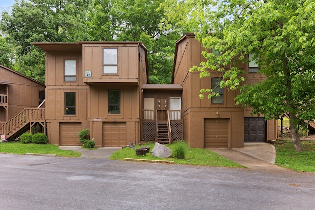 42-1 Woodson Bend Resort, Bronston, KY 42518 - townhome / multi-family property featuring stairway, a garage, board and batten siding, and a chimney