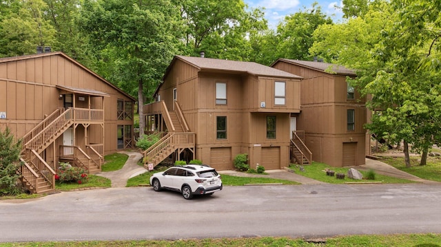 42-1 Woodson Bend Resort, Bronston, KY 42518 - view of building exterior with stairway, asphalt driveway, and a garage