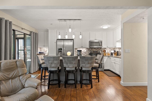 42-1 Woodson Bend Resort, Bronston, KY 42518 - kitchen with appliances with stainless steel finishes, open floor plan, tasteful backsplash, and a breakfast bar