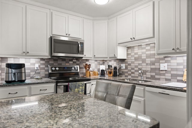 42-1 Woodson Bend Resort, Bronston, KY 42518 - kitchen with stainless steel appliances, a sink, white cabinetry, decorative backsplash, and light stone countertops