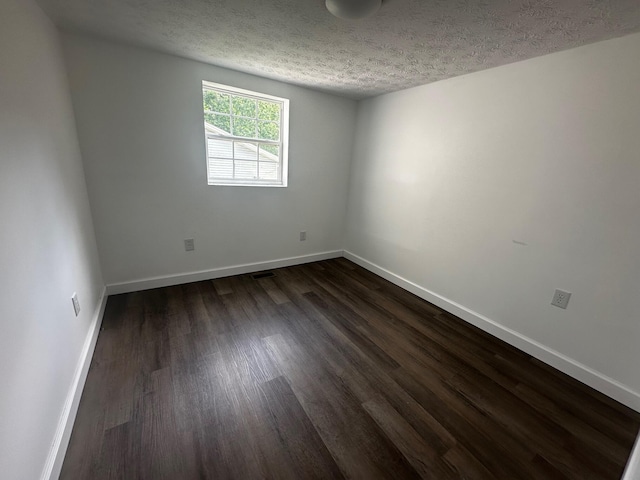 1901 Holly Grove Rd, Corbin, KY 40701 - empty room featuring dark wood-style flooring, a textured ceiling, and baseboards