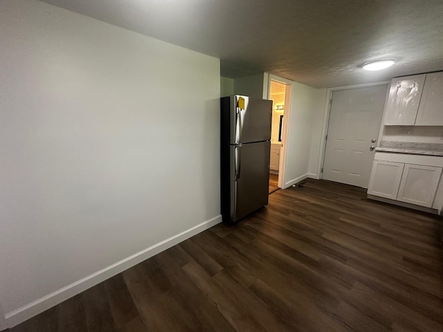 1901 Holly Grove Rd, Corbin, KY 40701 - kitchen featuring freestanding refrigerator, dark wood-style flooring, baseboards, and white cabinets