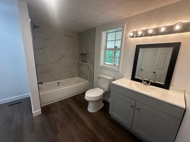 1901 Holly Grove Rd, Corbin, KY 40701 - bathroom featuring vanity, wood finished floors, toilet, a textured ceiling, and  shower combination