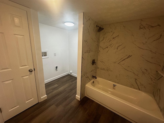 1901 Holly Grove Rd, Corbin, KY 40701 - bathroom featuring baseboards, bathing tub / shower combination, a textured ceiling, and wood finished floors