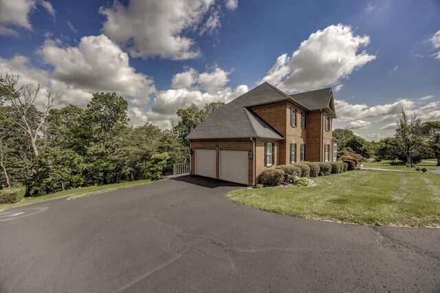 115 Old Bridge Rd, Danville, KY 40422 - view of side of home with brick siding, asphalt driveway, a yard, a garage, and roof with shingles