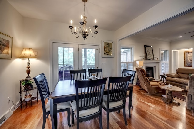 115 Old Bridge Rd, Danville, KY 40422 - dining room featuring a chandelier, light wood-type flooring, a glass covered fireplace, and ornamental molding