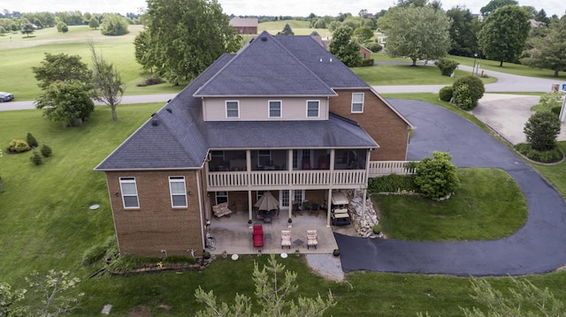 115 Old Bridge Rd, Danville, KY 40422 - rear view of property featuring a patio area, brick siding, a lawn, a shingled roof, and a sunroom