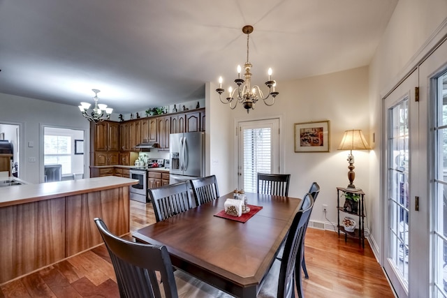 115 Old Bridge Rd, Danville, KY 40422 - dining space with a chandelier, light wood-style floors, and baseboards