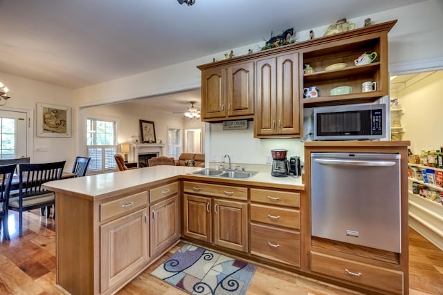 115 Old Bridge Rd, Danville, KY 40422 - kitchen with appliances with stainless steel finishes, a sink, a peninsula, a fireplace, and light countertops