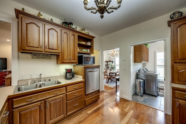 115 Old Bridge Rd, Danville, KY 40422 - kitchen featuring a sink, appliances with stainless steel finishes, a chandelier, washer and dryer, and plenty of natural light