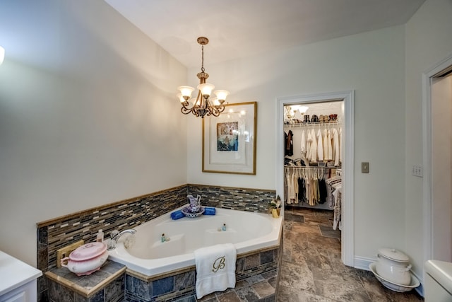 115 Old Bridge Rd, Danville, KY 40422 - bathroom featuring a garden tub, stone finish floors, a chandelier, toilet, and a spacious closet