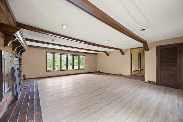 99 Wilson Ln, London, KY 40741 - unfurnished living room featuring wood finished floors, a brick fireplace, beamed ceiling, and baseboards