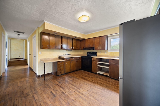 99 Wilson Ln, London, KY 40741 - kitchen with freestanding refrigerator, black electric range oven, light countertops, dark wood-style flooring, and a textured ceiling