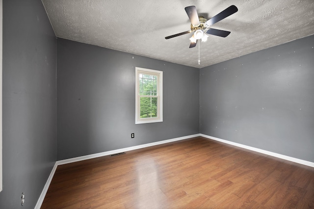 99 Wilson Ln, London, KY 40741 - unfurnished room featuring wood finished floors, a textured ceiling, baseboards, and a ceiling fan