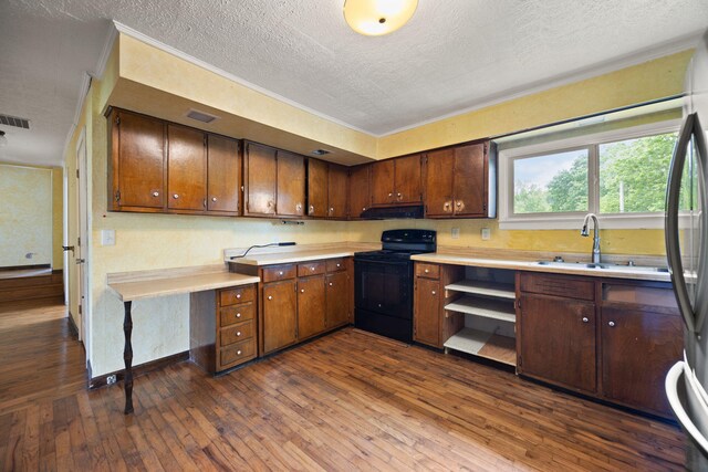 99 Wilson Ln, London, KY 40741 - kitchen with black electric range, a textured ceiling, light countertops, dark wood finished floors, and freestanding refrigerator