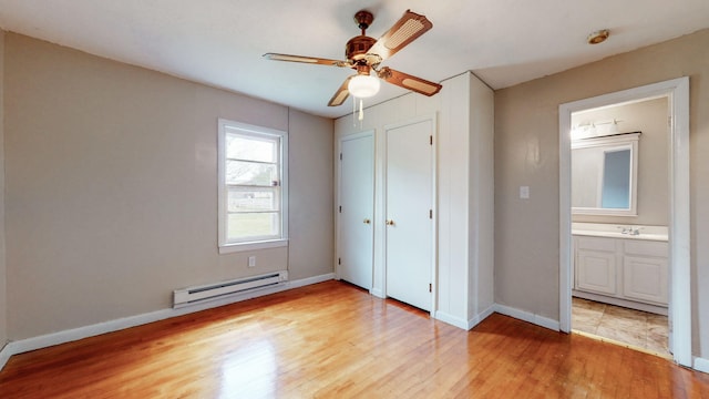 220 Johnson Ln, Berea, KY 40403 - unfurnished bedroom with a baseboard heating unit, light wood-style floors, baseboards, and ensuite bath