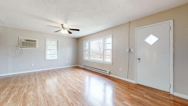 220 Johnson Ln, Berea, KY 40403 - foyer with a baseboard radiator, a wall unit AC, wood finished floors, ceiling fan, and a textured ceiling