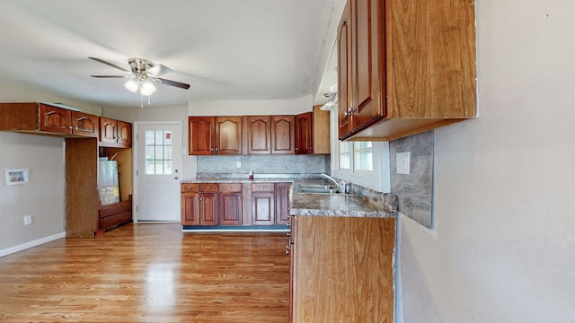 220 Johnson Ln, Berea, KY 40403 - kitchen featuring a sink, ceiling fan, light wood-style flooring, water heater, and decorative backsplash