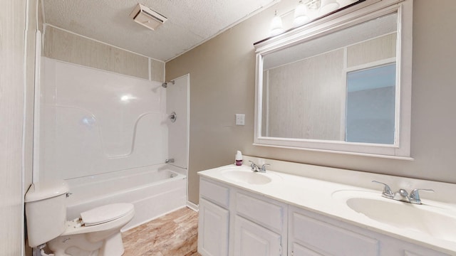 220 Johnson Ln, Berea, KY 40403 - full bath featuring toilet, double vanity, a textured ceiling, and shower / tub combination