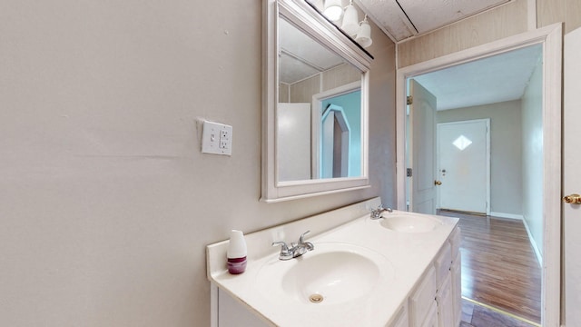 220 Johnson Ln, Berea, KY 40403 - bathroom featuring double vanity, wood finished floors, and baseboards