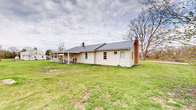 220 Johnson Ln, Berea, KY 40403 - rear view of house with a chimney, a yard, metal roof, and a sunroom