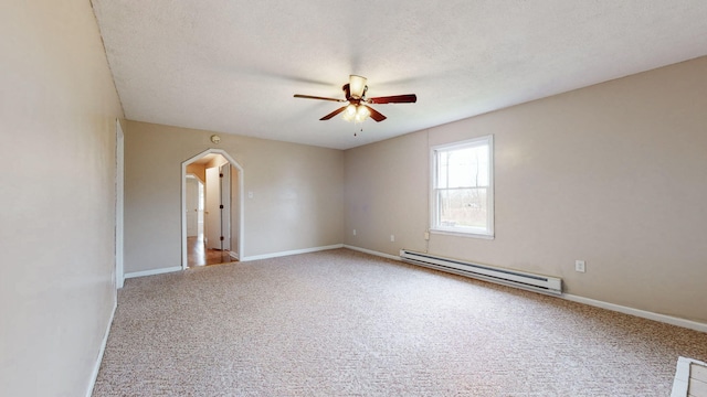 220 Johnson Ln, Berea, KY 40403 - carpeted spare room featuring a baseboard radiator, a ceiling fan, arched walkways, baseboards, and a textured ceiling