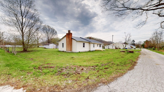 220 Johnson Ln, Berea, KY 40403 - view of side of property featuring a chimney, a lawn, and metal roof
