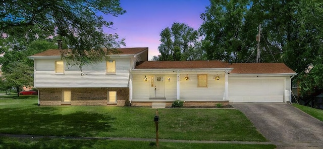 4513 Graves Dr, Lexington, KY 40515 - tri-level home with a yard, driveway, a porch, and a garage