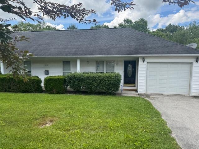 77 Bethy Rd, London, KY 40744 - view of front facade featuring a front lawn, a garage, driveway, and a shingled roof