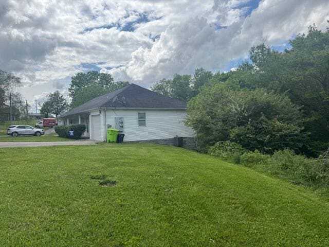 77 Bethy Rd, London, KY 40744 - view of side of property featuring driveway, a lawn, an attached garage, and central AC unit